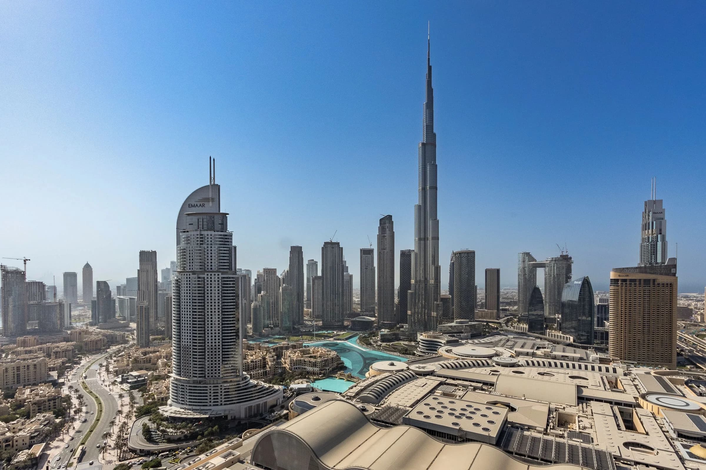 Aerial view of the Burj Khalifa and Downtown Dubai skyline over the fountain lake in clear daylight