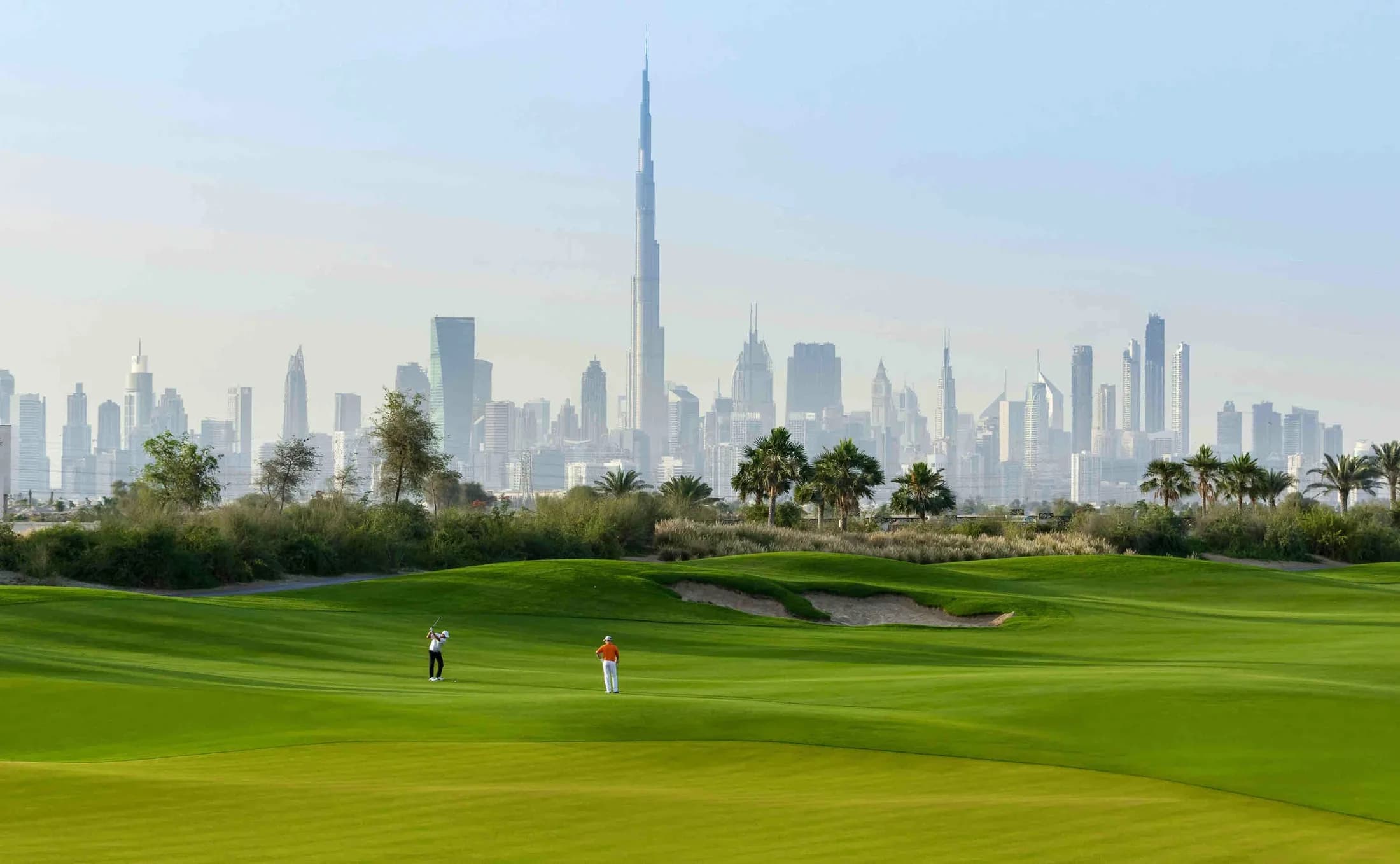 Dubai Hills Golf Club with the Downtown Dubai skyline in the background